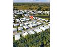 Scenic aerial view of a vibrant residential community near a tranquil body of water and lush greenery at 4527 13Th E St, Ellenton, FL 34222