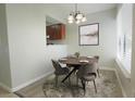 Cozy dining area featuring a round table with seating for four and a stylish overhead light fixture at 4906 25Th W St # 106, Bradenton, FL 34207