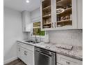 Modern kitchen featuring granite countertops, stainless steel appliances, and white cabinetry at 5019 Village Gardens Dr # 31, Sarasota, FL 34234