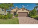 Attractive single-Gathering home boasting a well-kept lawn, manicured landscaping, and a welcoming facade at 5361 Sundew Dr, Sarasota, FL 34238
