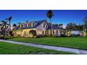 Stunning exterior view of the luxury home with lush green lawn at 7715 Westmoreland Dr, Sarasota, FL 34243