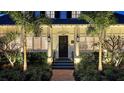 Beautiful front entrance with palm trees, landscaping, and updated stairs at 7715 Westmoreland Dr, Sarasota, FL 34243