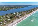 Beautiful aerial view of waterfront property with pristine beach access and serene landscape at 8270 Manasota Key Rd, Englewood, FL 34223