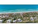 Breathtaking aerial view showcasing a beachfront property surrounded by tropical landscape at 8270 Manasota Key Rd, Englewood, FL 34223