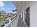 Spacious balcony with white railing overlooking the water and boat docks, offering serene views at 902 Gibbs Rd # 282, Venice, FL 34285