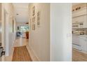 Bright hallway leading to a modern kitchen and spacious living area at 9570 High Gate Dr # 1722, Sarasota, FL 34238