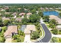 Gorgeous aerial view of neighborhood homes with mature trees, a lake, and lush landscaping at 9734 51St Terr E, Bradenton, FL 34211