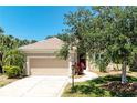Lovely home with a well-manicured lawn, tall palms, and a two-car garage providing ample parking at 9734 51St Terr E, Bradenton, FL 34211