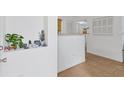 Bright entryway featuring neutral wall paint, tile flooring, and decorative shelving with decor accents at 1110 Villagio Cir # 103, Sarasota, FL 34237