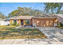 Charming single-story home with a well-manicured lawn, two-car garage, and inviting curb appeal at 11213 2Nd E Ave, Bradenton, FL 34212