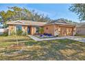 Inviting single-story home featuring a landscaped front yard and attached two-car garage at 11213 2Nd E Ave, Bradenton, FL 34212