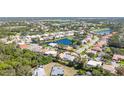 Aerial view showcasing the home's location within a vibrant community, featuring a lake and golf course at 129 Wayforest Dr, Venice, FL 34292