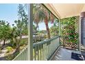 Balcony showcasing a charming outdoor setting with a lush garden view, providing an inviting and peaceful retreat at 1519 Pelican Point Dr # 288, Sarasota, FL 34231