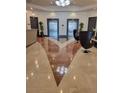 A grand lobby featuring elegant tile flooring, comfortable seating, and modern elevator access at 1771 Ringling Blvd # 902, Sarasota, FL 34236