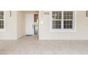 Inviting entrance with a white front door, natural lighting, and clean, neutral tones at 280 Hidden Bay Dr # 202, Osprey, FL 34229