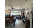 Inviting living and dining area featuring tile floors and a ceiling fan at 3013 Yarmouth W Dr, Bradenton, FL 34205