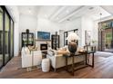 Bright living room featuring a fireplace, stylish decor, and comfortable seating arrangements at 329 Bird Key Dr, Sarasota, FL 34236