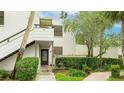 Condo's facade showcases a private entrance, stairway, and tasteful landscaping at 333 Springdale Dr # 333, Bradenton, FL 34210