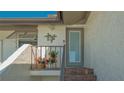 Inviting entryway with decorative accents and blooming potted plants at 4234 Gulf Of Mexico Dr # Q2, Longboat Key, FL 34228