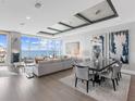 Open-concept living and dining area with ocean views and modern decor at 540 N Tamiami Trl # 1503, Sarasota, FL 34236