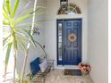 Inviting entryway featuring a stylish blue front door, decorative accents, and a cozy bench at 5515 Simonton St, Bradenton, FL 34203