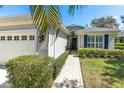 Charming home featuring a neatly landscaped front yard with a brick walkway leading to the entrance at 5515 Simonton St, Bradenton, FL 34203
