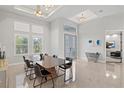 Formal dining room with ample natural light, a long dining table, and modern decor at 556 Regatta Way, Bradenton, FL 34208