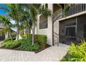 Close up of entrance with landscaping, staircase, and secure screen door with a small railing at 5694 Palmer Cir # 204, Lakewood Ranch, FL 34211