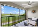 The lanai features relaxing seating with golf course views and a ceiling fan for outdoor comfort at 5694 Palmer Cir # 204, Lakewood Ranch, FL 34211