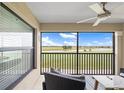 Enjoy scenic views of the golf course from this screened-in lanai with comfortable seating and a ceiling fan at 5694 Palmer Cir # 204, Lakewood Ranch, FL 34211