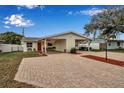 Attractive single-story home with brick driveway, yellow siding, and a covered carport area at 5808 18Th W St # A & B, Bradenton, FL 34207