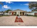Duplex featuring matching units with red doors, covered parking, and brick-accented landscaping at 5808 18Th W St # A & B, Bradenton, FL 34207