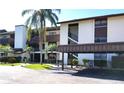Exterior view of Timber Creek condo complex featuring covered parking and lush landscaping at 6012 Oak Creek Ln # 1913, Bradenton, FL 34210