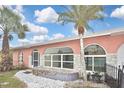 Lovely single-story home with arched windows and landscaped front yard, plus stylish stone accents at 6023 Mayberry Ave, North Port, FL 34287
