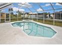 Sparkling screened-in pool with a relaxing hot tub, perfect for outdoor enjoyment at 6023 Mayberry Ave, North Port, FL 34287