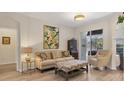 Bright living room showcasing neutral walls, light wood floors and sliding doors to patio at 6357 Royal Tern Cir, Lakewood Ranch, FL 34202