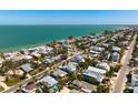 Stunning aerial view of a coastal neighborhood with beautiful beaches and turquoise waters at 709 N Bay Blvd, Anna Maria, FL 34216