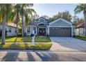 Beautifully landscaped front yard and driveway lead to the inviting two-car garage at 7135 Royal George Ct, Wesley Chapel, FL 33545