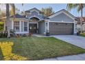 Well-manicured lawn, lovely plantings and double front doors add to the curb appeal at 7135 Royal George Ct, Wesley Chapel, FL 33545