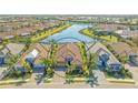 Stunning aerial view of a private home near a pond in a beautiful community with lush surroundings at 7213 Whittlebury Trl, Bradenton, FL 34202
