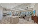 Bright open-concept floorplan featuring island kitchen, dining, and living room with water views at 7213 Whittlebury Trl, Lakewood Ranch, FL 34202