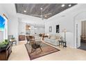 Bright and airy living room with a unique ceiling, tile flooring, and lots of seating at 7317 Emma Rd, Bradenton, FL 34209