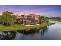 An elevated rear view shows the pool and covered patio and the home's proximity to the water at 7327 Greystone St, Lakewood Ranch, FL 34202