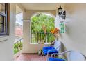 Cozy balcony with seating and views of the tropical landscaping, creating a relaxing outdoor space at 7674 Fairway Woods Dr # 1605, Sarasota, FL 34238