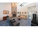 Inviting living room boasts a dramatic stone fireplace, vaulted ceiling, comfortable seating, and lots of natural light at 7816 15Th Nw Ave, Bradenton, FL 34209