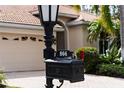 Up close shot of the home's mailbox with number plaque and a partial view of the home and two-car garage at 866 Placid Lake Dr, Osprey, FL 34229