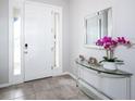 Bright foyer showcasing tile floors, natural light, and stylish decor at 8681 Daydream St, Sarasota, FL 34238