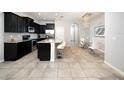 Modern kitchen featuring dark cabinets, a large island, and stainless steel appliances at 8681 Daydream St, Sarasota, FL 34238