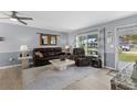 Inviting living room featuring comfortable seating, neutral paint, and plenty of natural light at 8719 Gaillard Ave, North Port, FL 34287