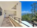 Hallway featuring tiled floors, multiple doors, and a scenic water view at 8779 Midnight Pass Rd # 406H, Sarasota, FL 34242